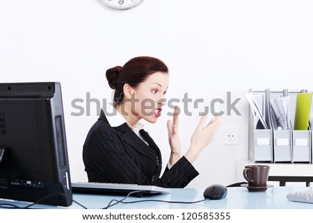 Angry businesswoman in office yellig on phone