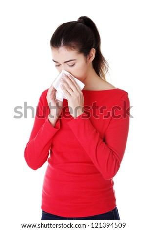 Young woman with tissue - sneezing , isolated on white