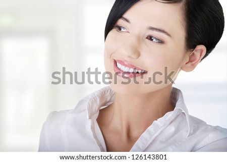 Closeup of a beautiful young businesswoman looking to the side.