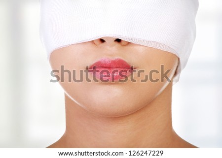 Portrait of beautiful young female face with bandage - beauty treatment plastic surgery