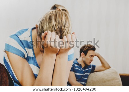 Couple after quarrel. Woman is crying and man takes offense.