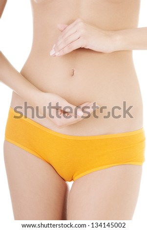 Fit and slim young woman belly with hand on it