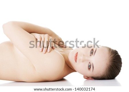 Sexy fit naked woman with healthy clean skin lying down, isolated on white