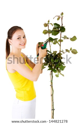Happy gardener using pruning scissors. Isolated on white.