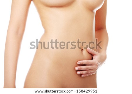 Beautiful nude fit woman body with hand on belly, isolated on white