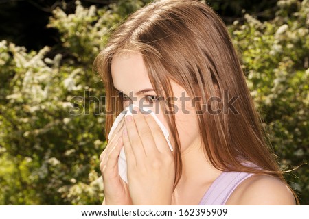 Attractive young woman outdoor with white tissue.