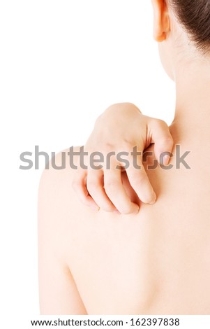 Attractive naked woman\'s body part. Scratching her back. Closeup.