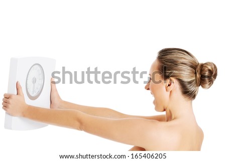 Nude topless woman holding scale Isolated on white Nude topless woman holding scale Isolated on white
