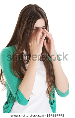 Young beautiful woman with sinus pressure, touching her nose. Isolated on white.