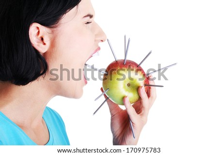 Throat pain concept. Woman eating apple with nails.