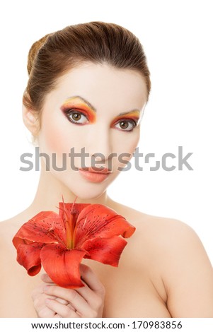 Beautiful woman with a red lily, isolated on white