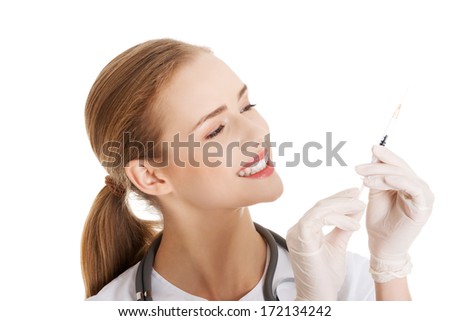 Beautiful young nurse or doctor with needle, shot ready to apply.  Isolated on white.
