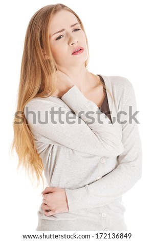 Beautiful casual woman is touching her neck. She\'s having neck- ache. Isolated on white.