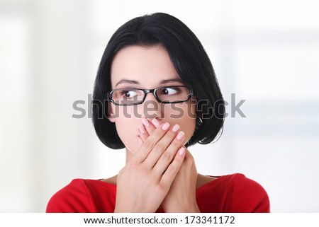 Shocked woman covering her mouth with hands, isolated on white