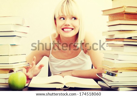 Young student woman with lots of books studying for exams. isolated on white background