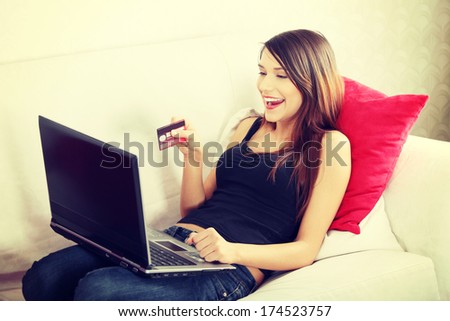 Young woman\'s sopping in internet. In home.
