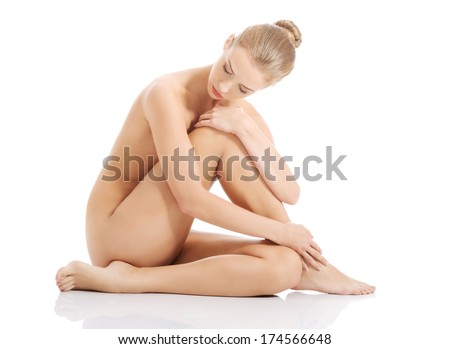 Beautiful caucasian naked woman sitting with fresh clean skin Isolated on white Beautiful caucasian naked woman sitting with fresh clean skin Isolated on white