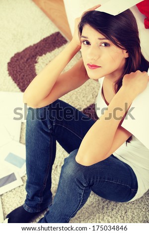 Young woman stressed because of high bills.