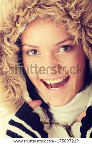 Teen woman in winter jacket with fur around her face
