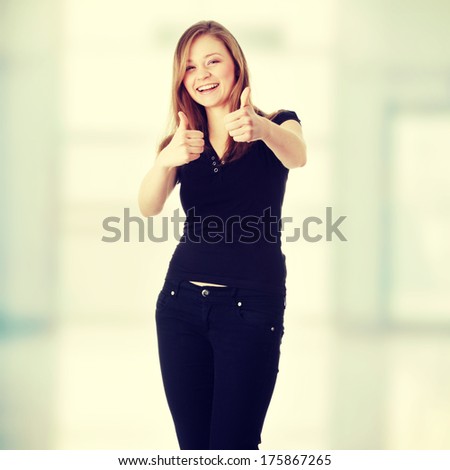 Happy young caucasian woman with thumbs up