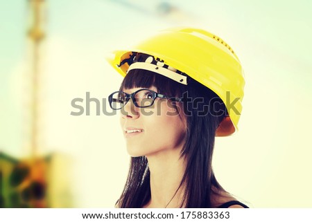 Engineer woman in yellow helmet