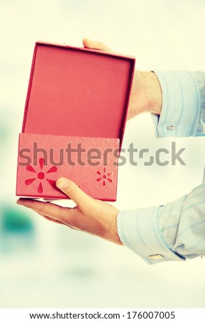Business man opening a gift
