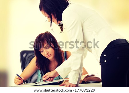 Teacher Helping teen Student One on One Teacher Helping teen Student One on One