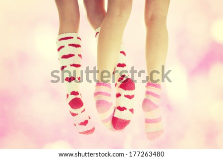 Four crossed legs with colorful socks - friendship or love concept