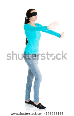 Portrait of the young blindfold woman using senses, isolated on white