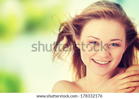 Sensual portrait of nude beautiful young blond caucasian woman, with tears in her eyes and wind in her hairs