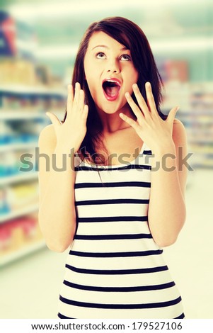 Shocked young woman in store