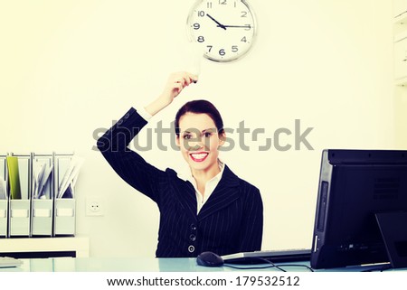 Pretty caucasian businesswoman holding a light bulb in the office.