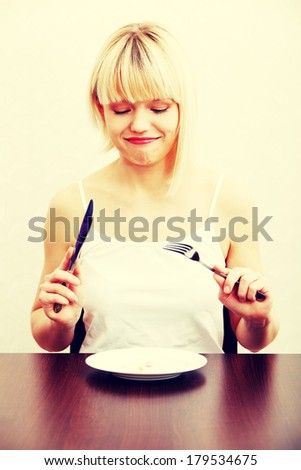 Woman eating nutritional supplement - pills on plate.