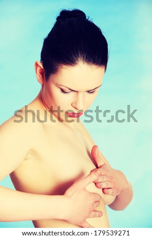 Breast cancer - Woman examining her breast