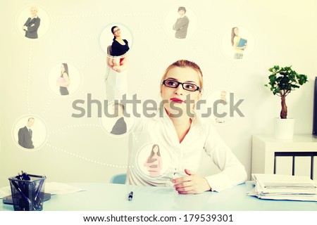 Businesswoman choosing the right worker of all applicants on an abstract button.