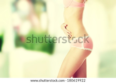 Closeup of young woman with hand on her stomach isolated