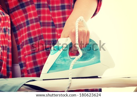 Happy young woman ironing on ironing board,isolated on white background.