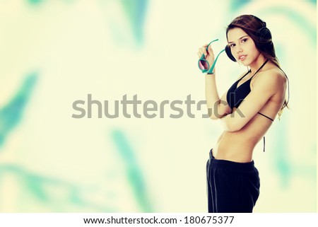 Listening to the Music, young caucasian beautiful woman with headphones, against blue graffiti
