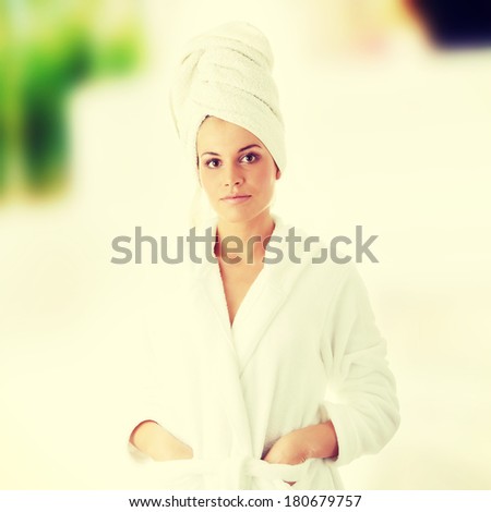 Beautiful young caucasian woman in bathrobe after bath calm portrait.