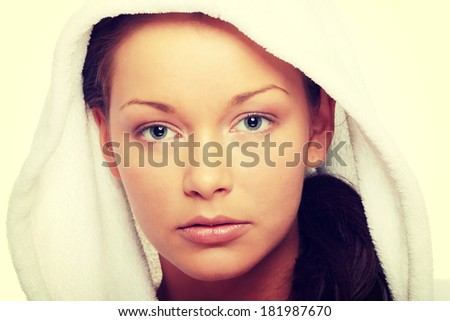 Beautiful young caucasian woman in bathrobe after bath calm portrait.
