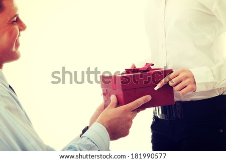 Business man offering a gift to a woman
