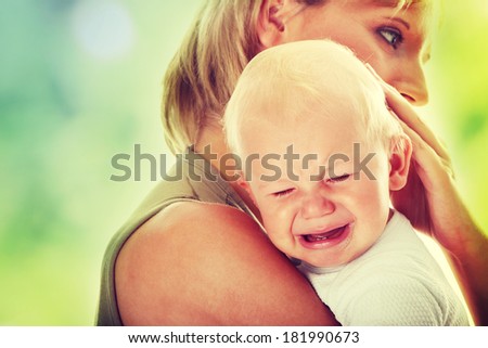 Mother holding her crying baby