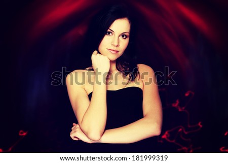 Portrait of a beautiful woman, over abstract dark background