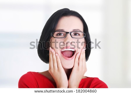 Shocked and excited woman looking up