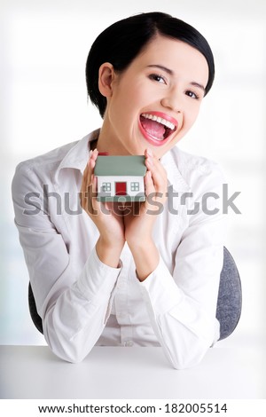 Female businesswoman hands holding and protecting house. Home protecting concept for insurance or security