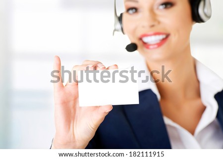 Smiling customer service representative with headset holding a blank empty card.