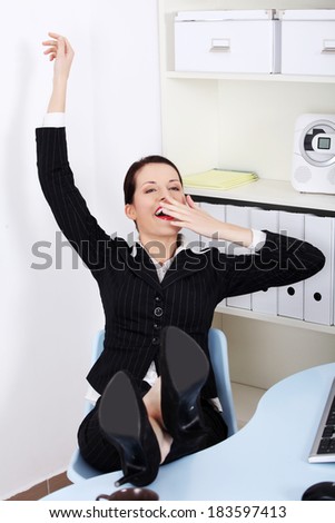 Business woman with legs on desk during break.