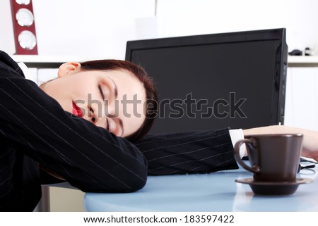 Business woman is sleeping on desk/table in office.
