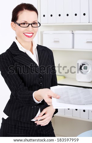 Business woman is giving the documents to someone, in office.
