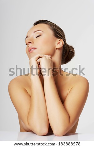 Portrait of a beautiful nude woman. Cut out.Over grey background.